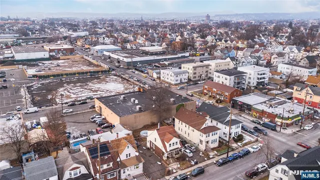 an aerial view of residential houses with city view