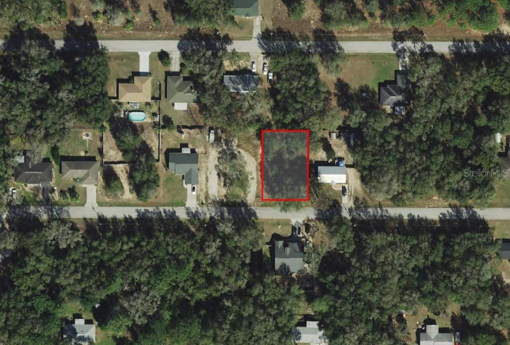 3973 East Dano Street Inverness, FL 34453 - Photo 1 of 4 a aerial view of a house with a yard and large trees