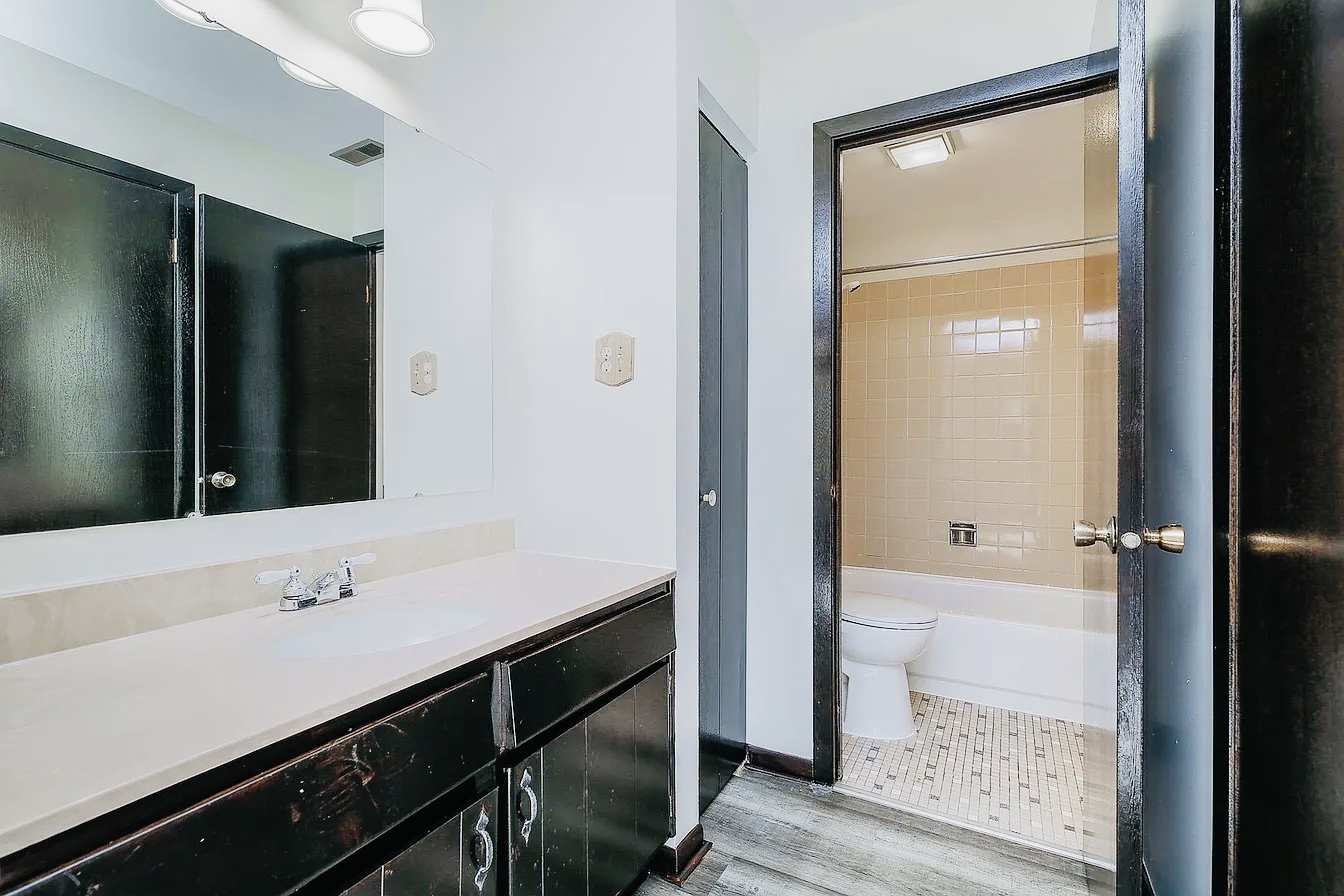 865 Sheldon Court, Unit C Wheaton, IL 60189 - Photo 7 of 11 a bathroom with a sink and a mirror