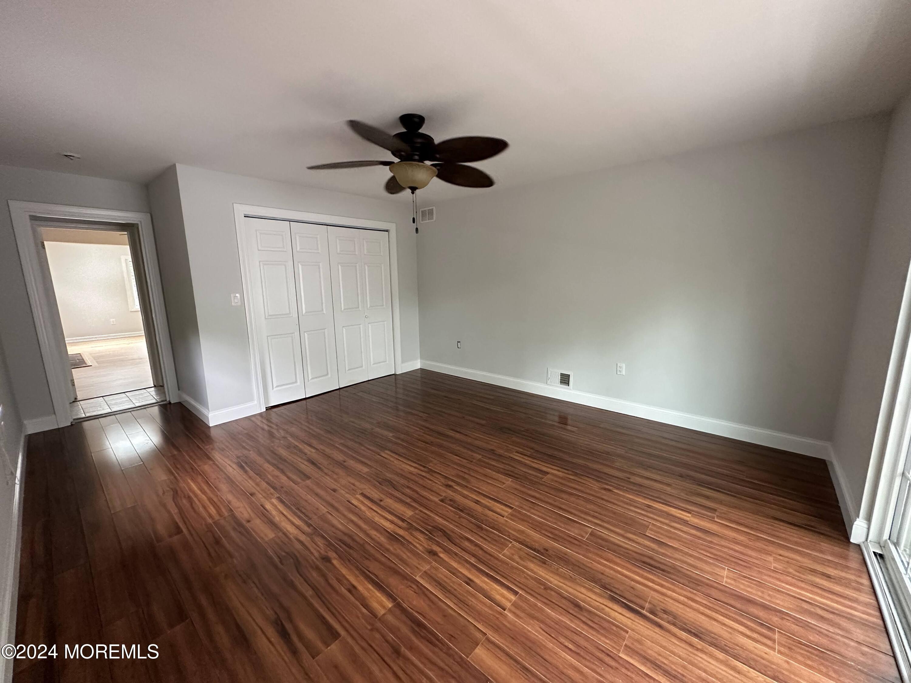 57 Kings Road Little Silver, NJ 07739 - Photo 16 of 22 a view of empty room with wooden floor and fan