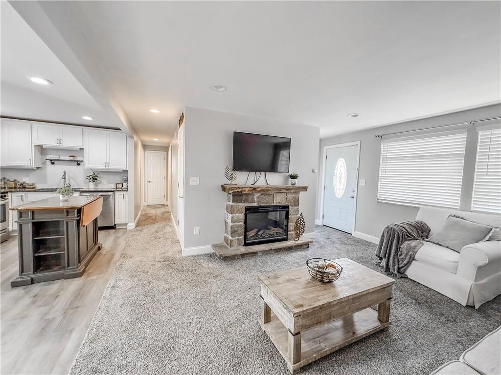 650 Lindsay Road Carnegie, PA 15106 - Photo 20 of 35 a living room with furniture a fireplace and a flat screen tv