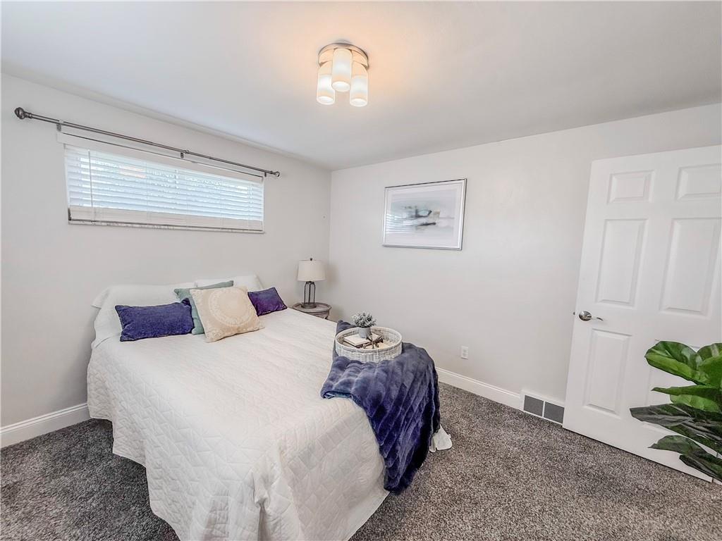 650 Lindsay Road Carnegie, PA 15106 - Photo 24 of 35 a bedroom with a bed and a chandelier