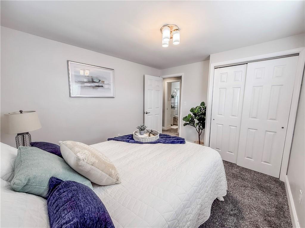 650 Lindsay Road Carnegie, PA 15106 - Photo 25 of 35 a bedroom with a bed and a chandelier