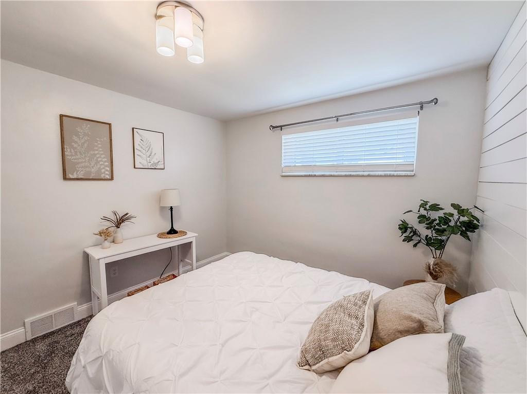 650 Lindsay Road Carnegie, PA 15106 - Photo 29 of 35 a bedroom with a bed and a potted plant