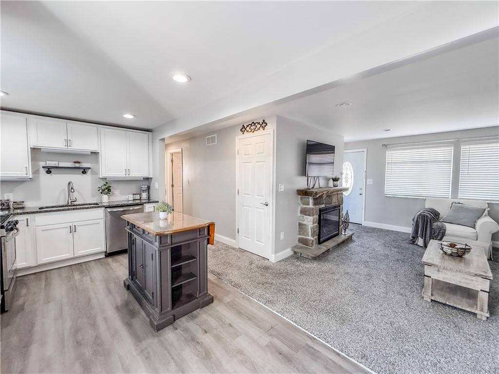 650 Lindsay Road Carnegie, PA 15106 - Photo 7 of 35 a kitchen with a sink and chairs