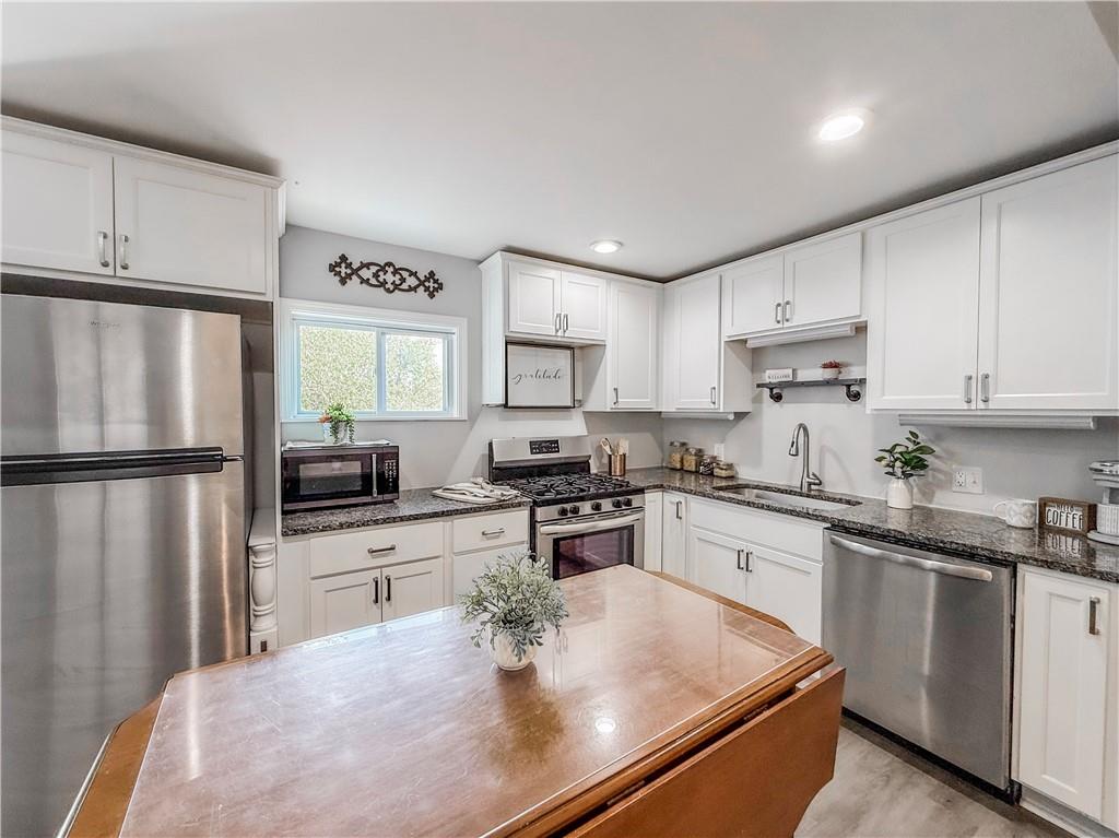 650 Lindsay Road Carnegie, PA 15106 - Photo 8 of 35 a kitchen with stainless steel appliances granite countertop a refrigerator sink stove microwave and cabinets