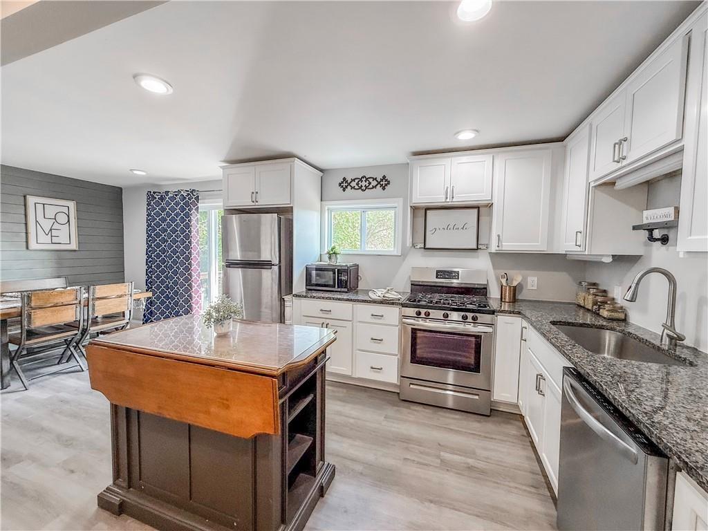 650 Lindsay Road Carnegie, PA 15106 - Photo 9 of 35 a kitchen with stainless steel appliances granite countertop a sink stove and refrigerator