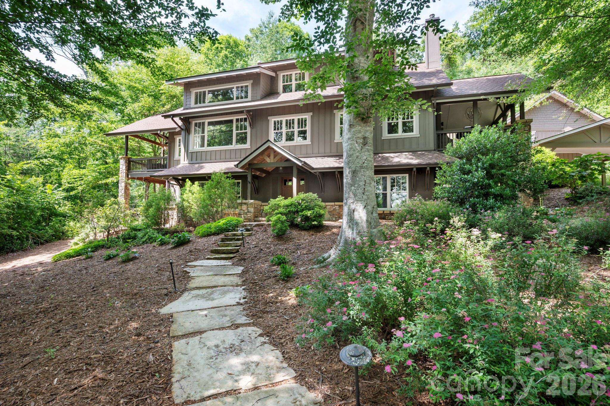 235 Bull Creek Road Asheville, NC 28805 - Photo 2 of 47 a front view of a house with a yard and potted plants