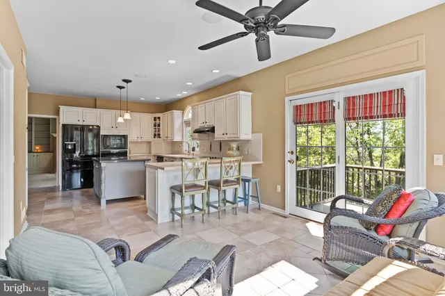 a kitchen with kitchen island granite countertop a stove a sink and a refrigerator