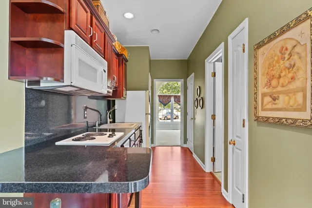 a spacious bathroom with a tub sink and a mirror