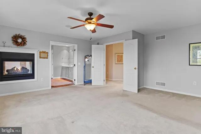 a room with pool table and windows