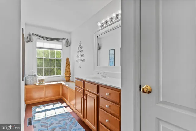 an aerial view of a house with a yard and mountain view in back
