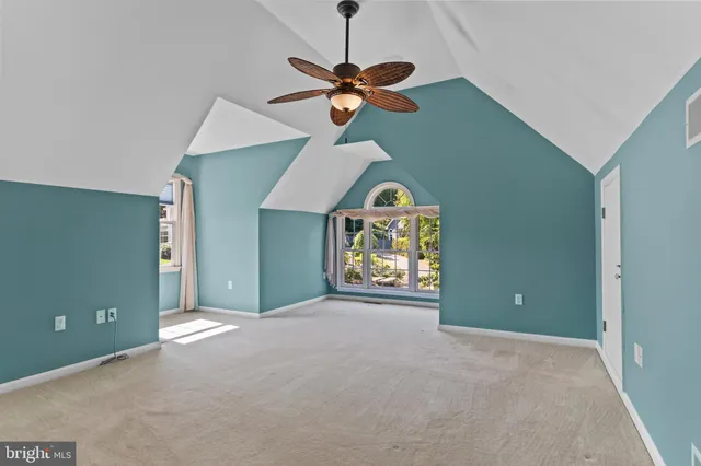 an aerial view of a house with a yard and lake view