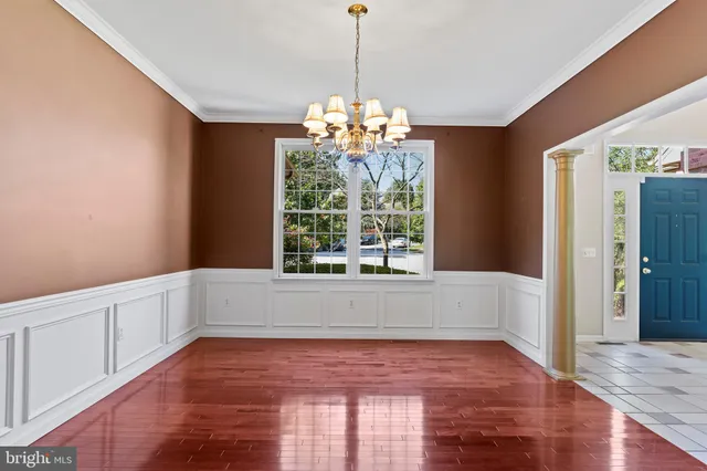 a balcony with wooden floor in front of a house