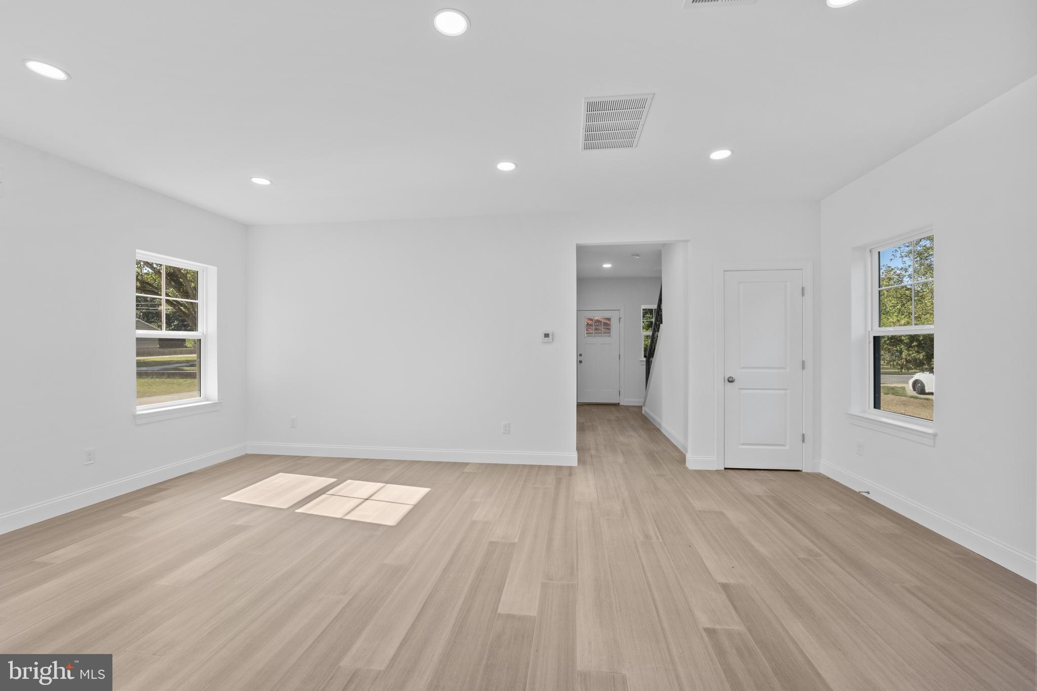 492 Ellis Avenue Lawnside, NJ 08045 - Photo 16 of 33 an empty room with wooden floor and windows