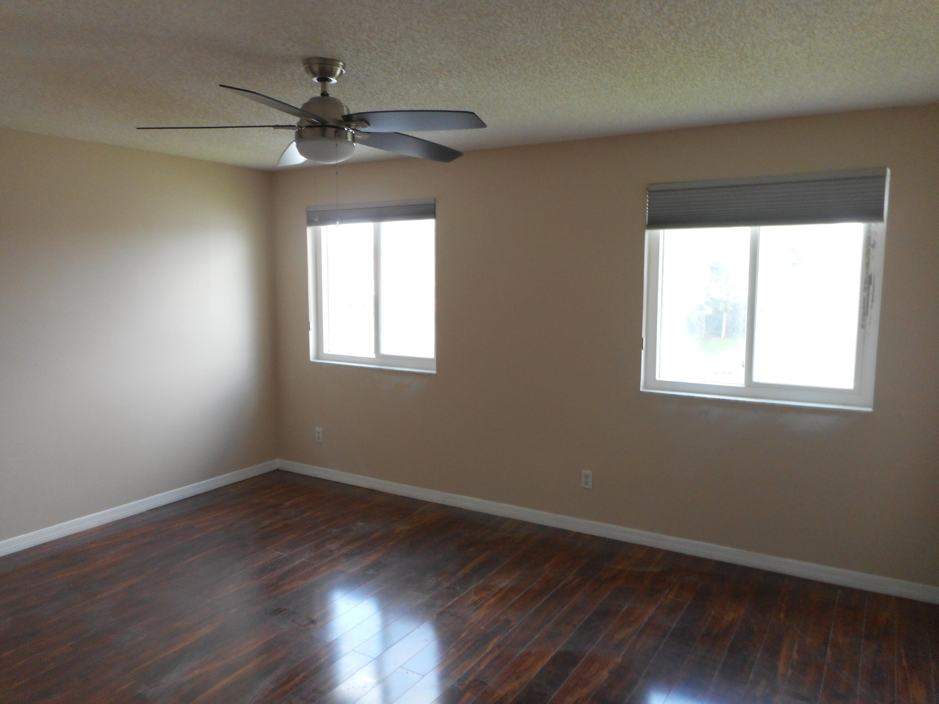 1741 Southwest 109th Terrace Davie, FL 33324 - Photo 11 of 30 a view of an empty room with wooden floor and a window