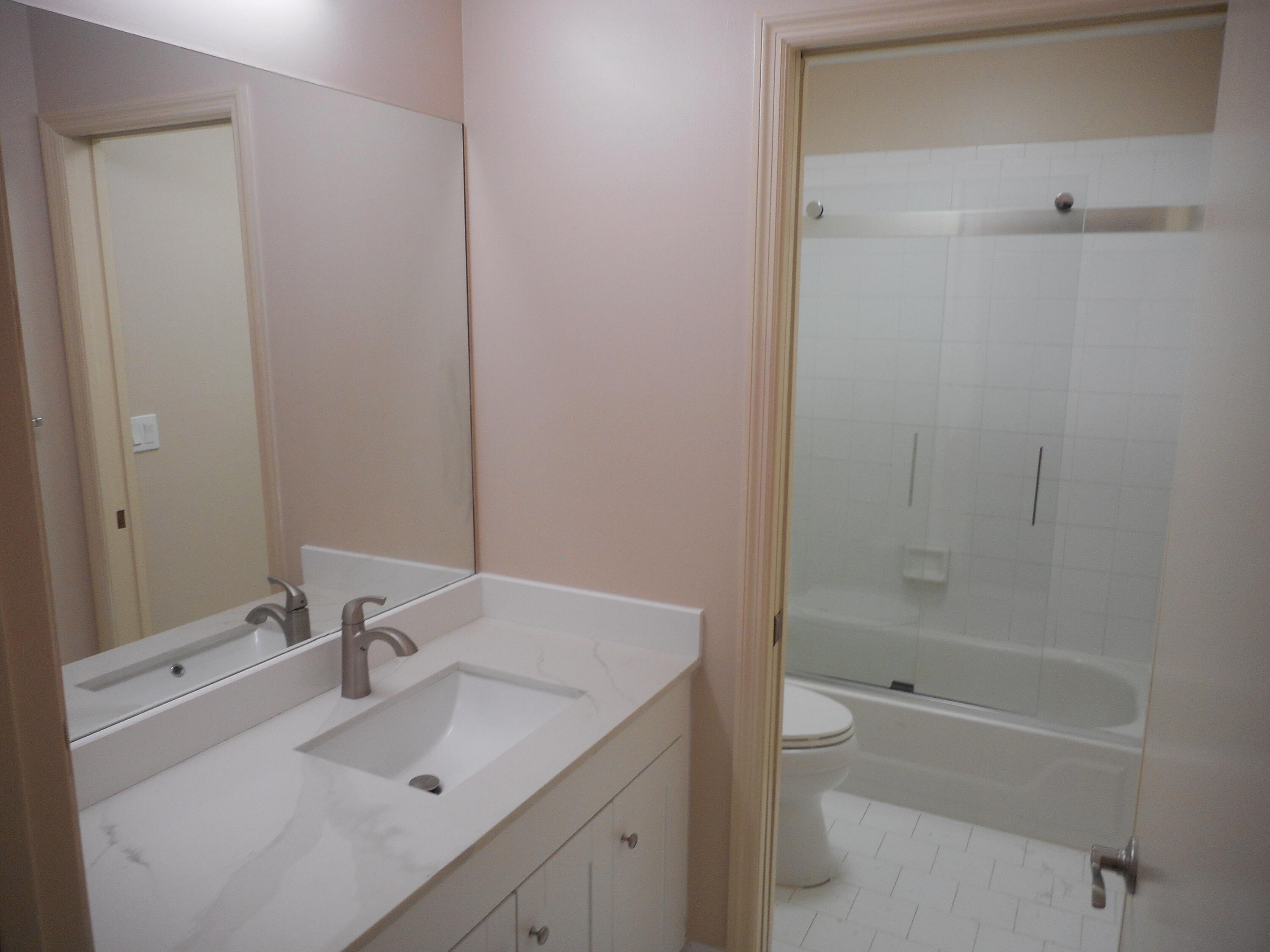 1741 Southwest 109th Terrace Davie, FL 33324 - Photo 22 of 30 a bathroom with a granite countertop sink a toilet and shower