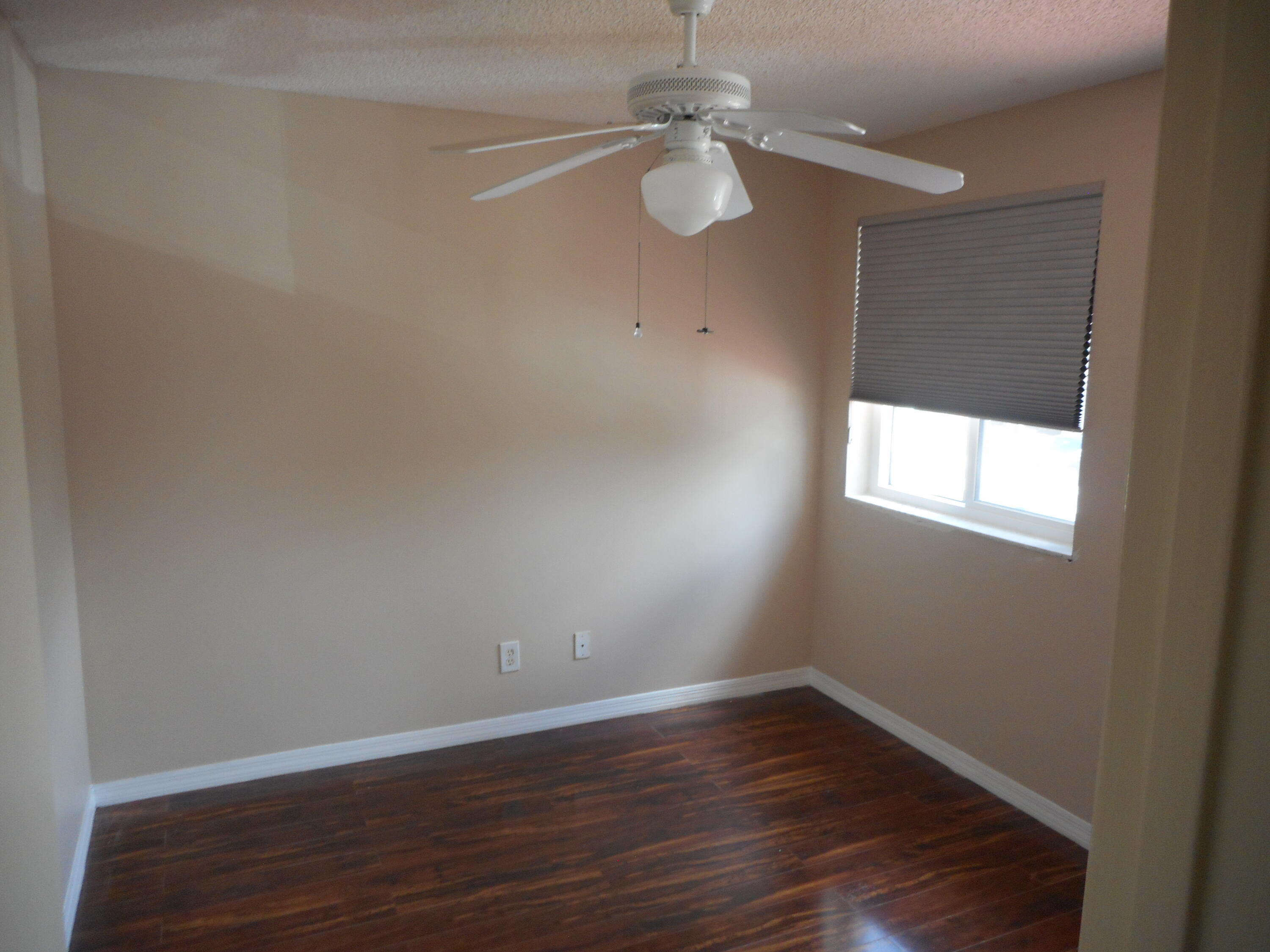 1741 Southwest 109th Terrace Davie, FL 33324 - Photo 23 of 30 a view of an empty room with wooden floor and a window