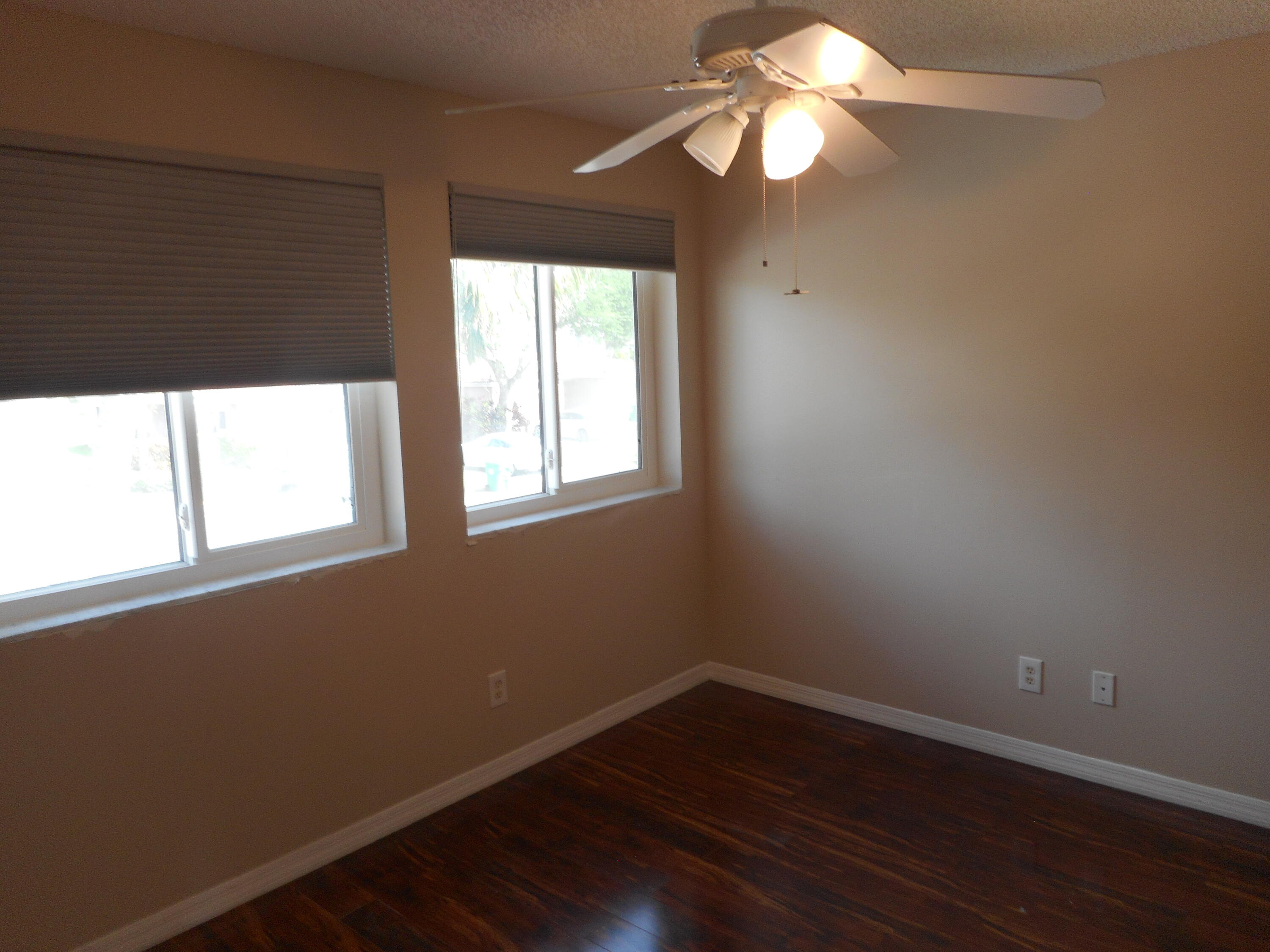 1741 Southwest 109th Terrace Davie, FL 33324 - Photo 27 of 30 a view of an empty room with wooden floor and a window