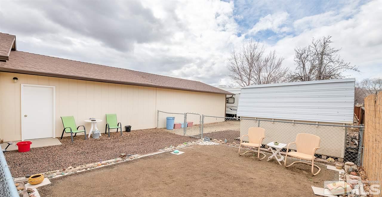 145 Ring Road Dayton, NV 89403 - Photo 13 of 17 a view of a patio with table and chairs and a barbeque