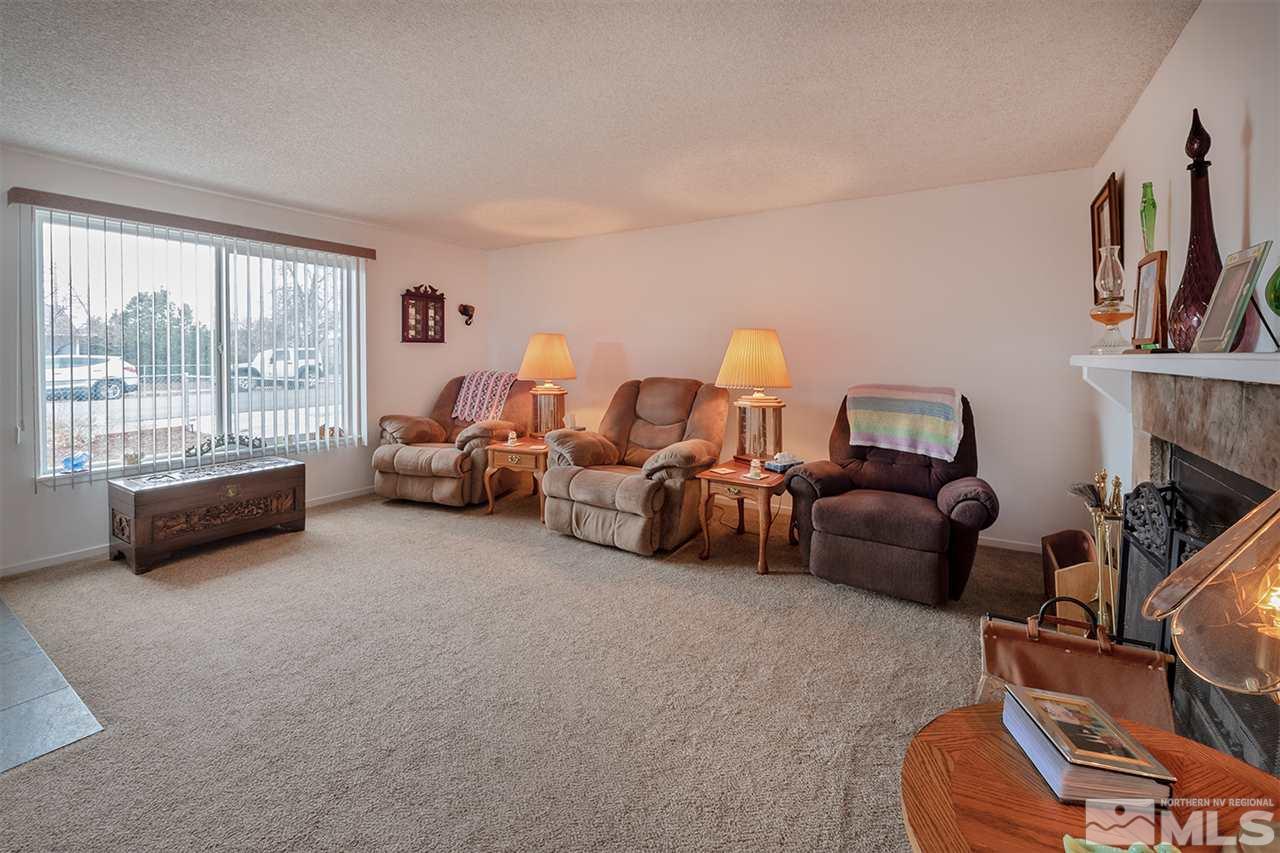 145 Ring Road Dayton, NV 89403 - Photo 3 of 17 a living room with furniture a flat screen tv and a large window