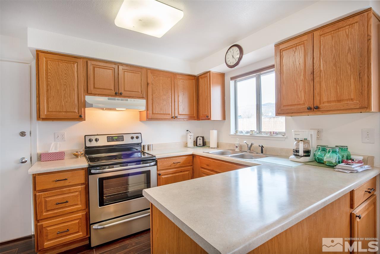 145 Ring Road Dayton, NV 89403 - Photo 5 of 17 a kitchen with stainless steel appliances granite countertop a sink a stove and cabinets