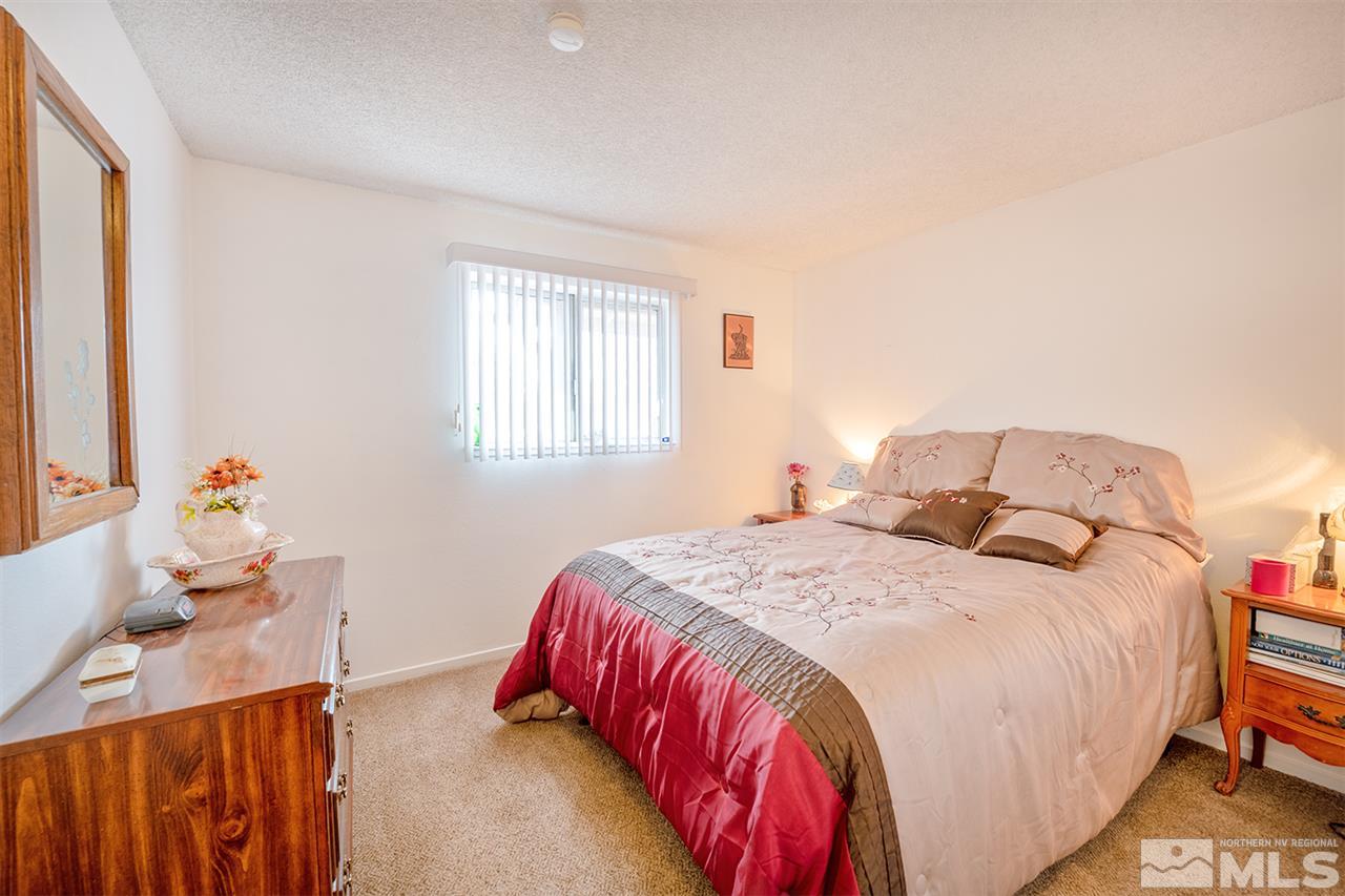 145 Ring Road Dayton, NV 89403 - Photo 8 of 17 a bedroom with a bed and window