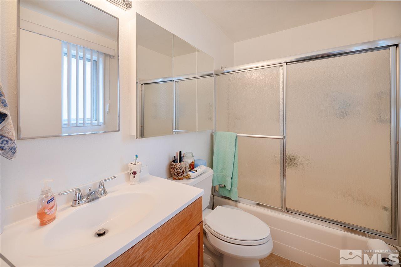 145 Ring Road Dayton, NV 89403 - Photo 9 of 17 a bathroom with a sink toilet and shower