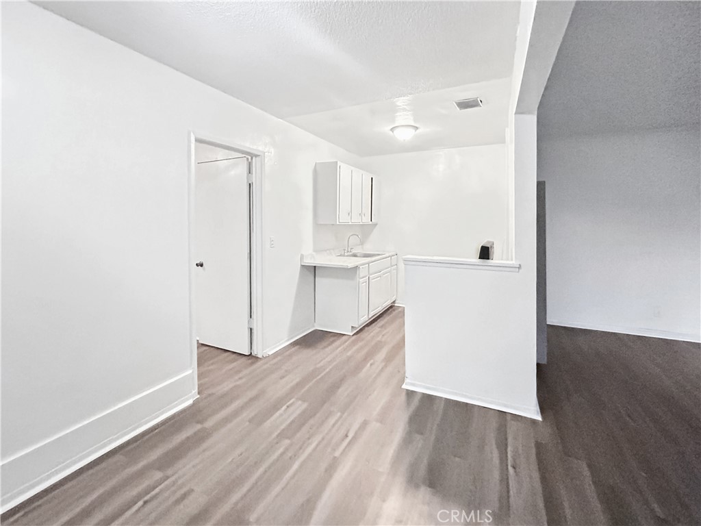 1109 South Minnie Street Santa Ana, CA 92701 - Photo 14 of 20 a view of a kitchen with wooden floor and a sink