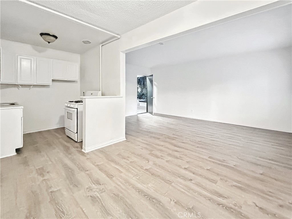 1109 South Minnie Street Santa Ana, CA 92701 - Photo 6 of 20 a view of a kitchen with wooden floor and electronic appliances