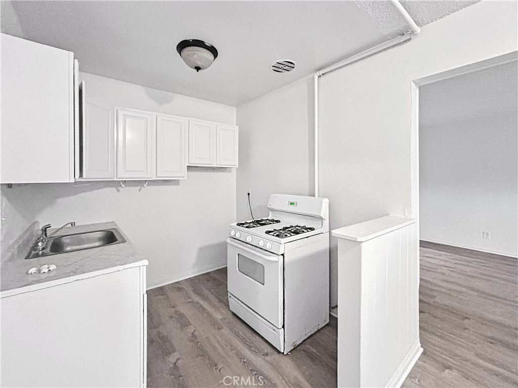 1109 South Minnie Street Santa Ana, CA 92701 - Photo 8 of 20 a kitchen with a stove and a microwave