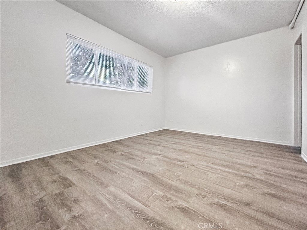 1109 South Minnie Street Santa Ana, CA 92701 - Photo 9 of 20 a view of empty room with wooden floor