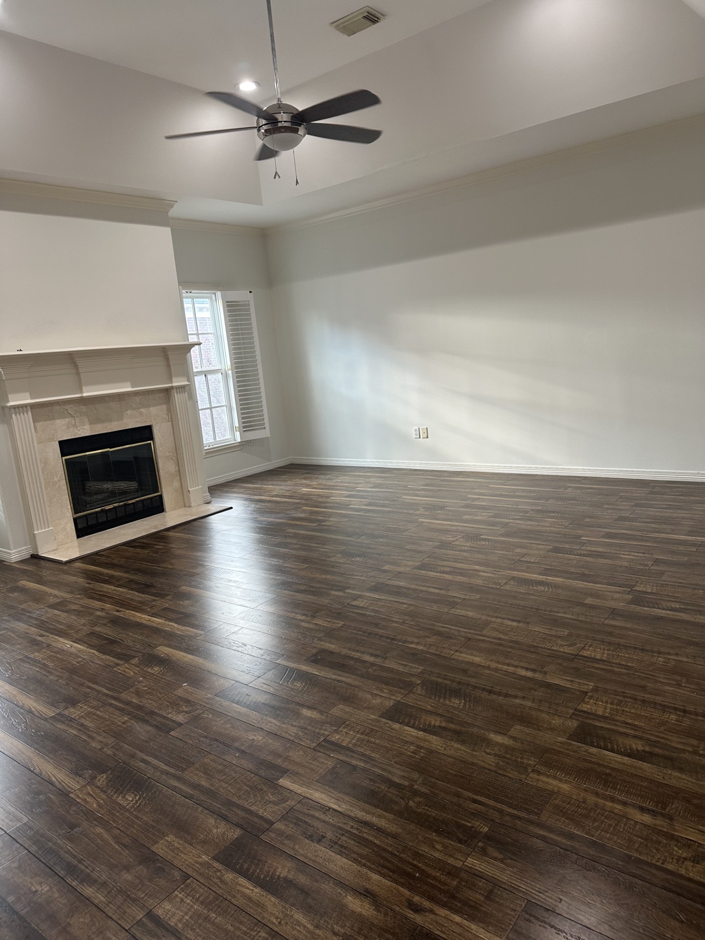 732 Highgrove Park Houston, TX 77024 - Photo 3 of 8 an empty room with wooden floor fireplace and windows