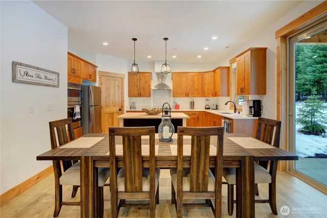 a kitchen with a sink a center island cabinets and a window