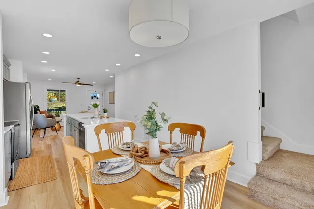 an empty room with wooden floor and a ceiling fan