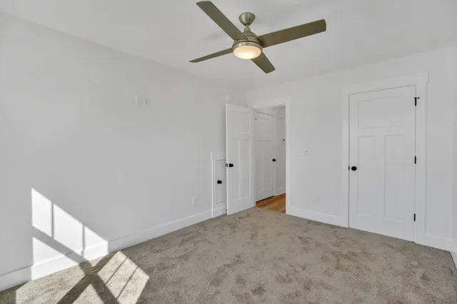 a white toilet and tub sitting next to a bathroom sink