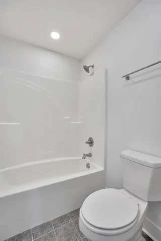 a bedroom with a bed and painting on the wall