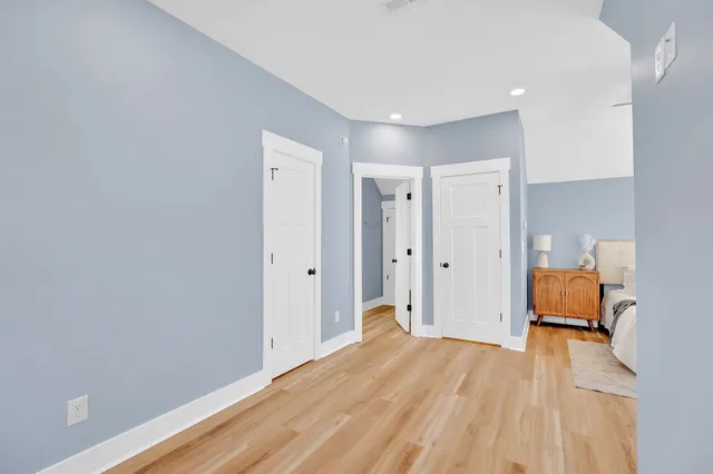 a bedroom with a bed and a chandelier