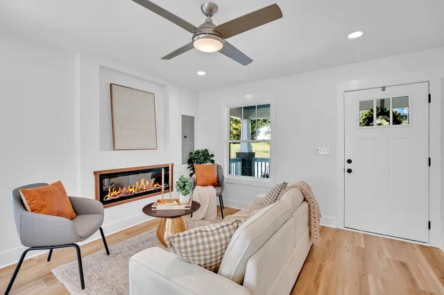 a living room with furniture and a wooden floor