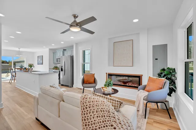 a living room with furniture and kitchen view