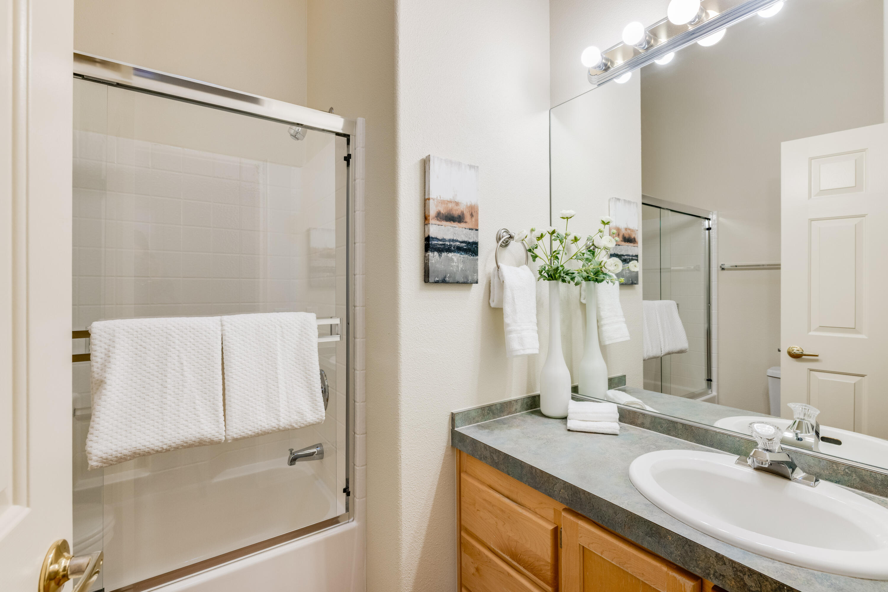 278 North Wheeler Loop Sisters, OR 97759 - Photo 17 of 22 a bathroom with a granite countertop shower sink and mirror
