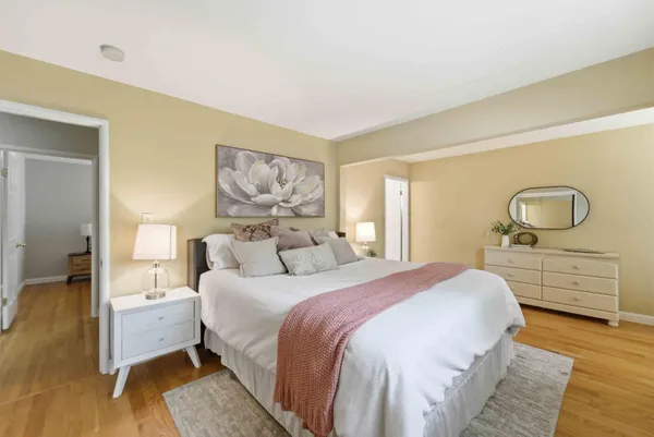 a bedroom with a bed and wooden floor