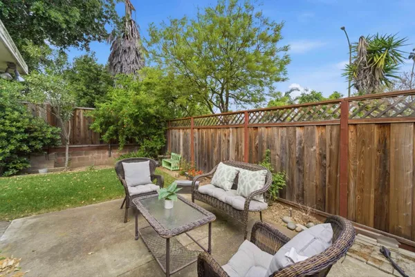 a backyard of a house with table and chairs