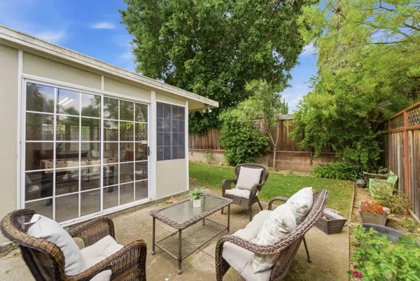 a view of a chair and table in the backyard