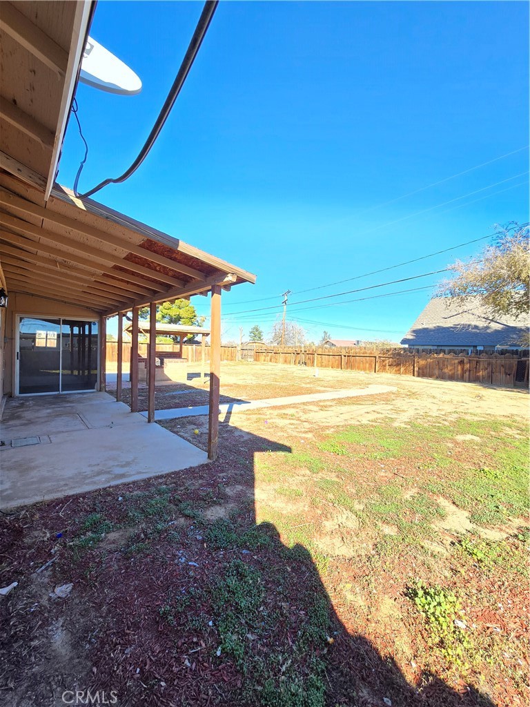 8651 S Loop California City, CA 93505 - Photo 15 of 16 a view of a swimming pool with an outdoor space and seating area