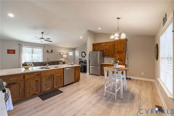 a large kitchen with a table and chairs in it