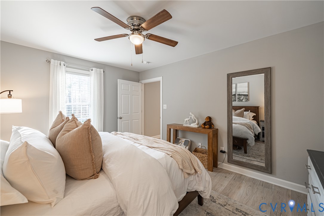 180 Barefords Mill Road Dunnsville, VA 22454 - Photo 18 of 27 a bedroom with a bed and a large window