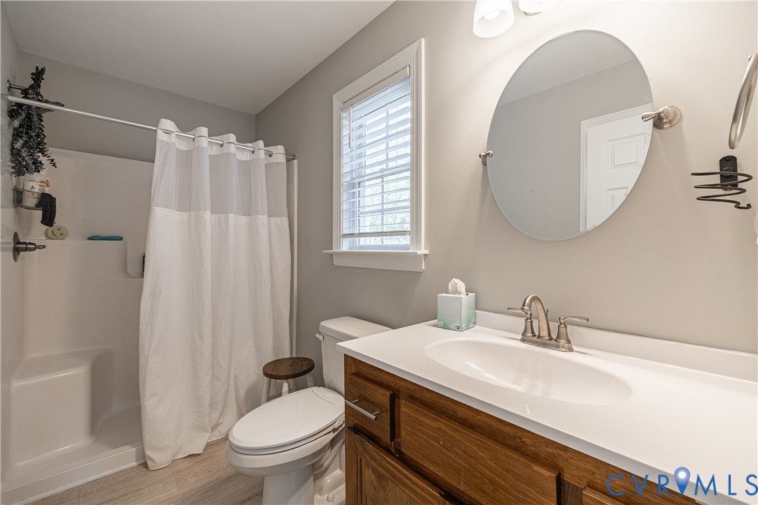 180 Barefords Mill Road Dunnsville, VA 22454 - Photo 19 of 27 a bathroom with a sink a toilet and a mirror