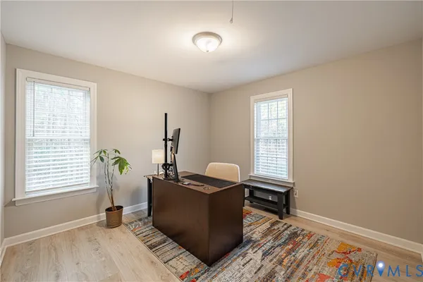a view of a workspace with furniture and a window