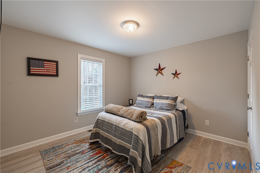 180 Barefords Mill Road Dunnsville, VA 22454 - Photo 22 of 27 a bedroom with a bed and a window